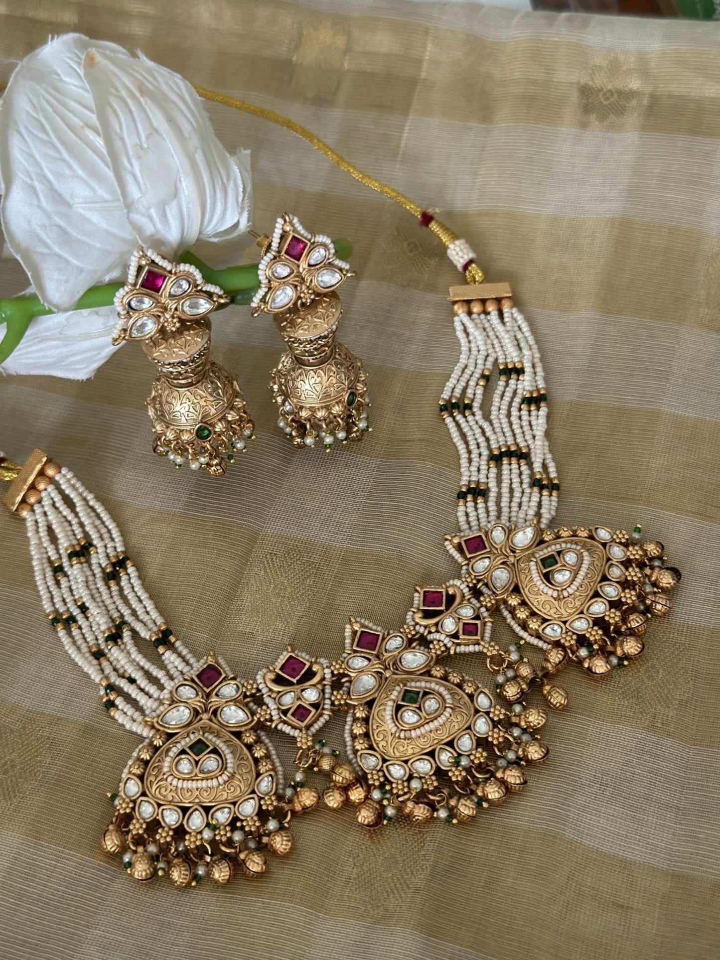 Traditional gold kundan polki set with jhumkis